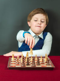 Portrait of boy playing chess