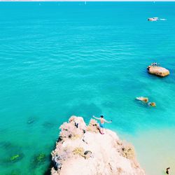 High angle view of man swimming in sea