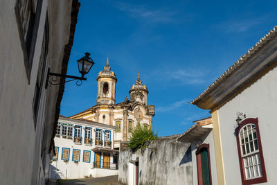 Low angle view of buildings against blue sky