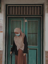 Woman standing against window