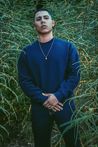 Portrait of young man standing on field