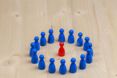 High angle view of pawns arranged on wooden table