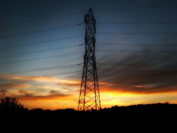 Low angle view of electricity pylon against sky