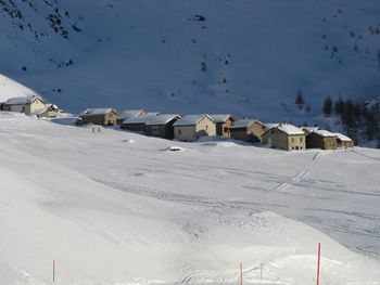 Snow covered landscape against mountain