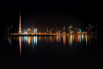 Skyline of illuminated buildings at waterfront