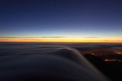 Scenic view of silhouette landscape against sky at night