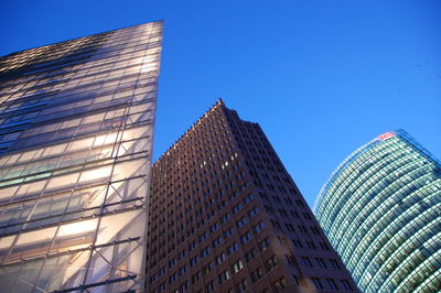 Low angle view of modern building against blue sky