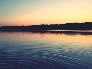 Scenic view of lake at sunset