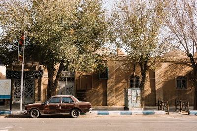 Cars on road by buildings in city