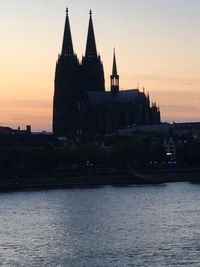 Silhouette built structure against sky during sunset