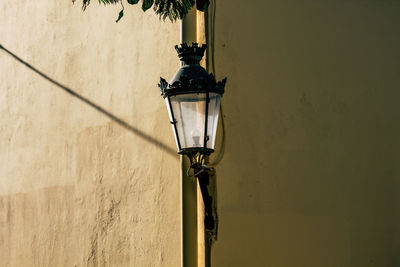 Low angle view of street light mounted on wall