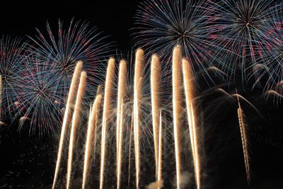 Low angle view of firework display at night