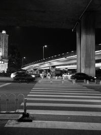 Illuminated tunnel at night