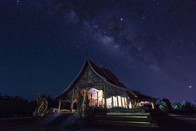 Traditional windmill against sky at night