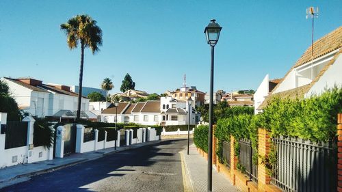 Street amidst buildings against clear sky at el conquero, huelva. 