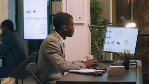 Side view of business colleagues working at office