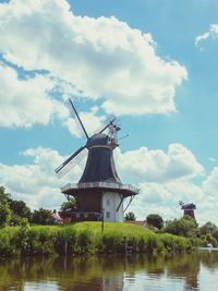 Traditional windmill against sky