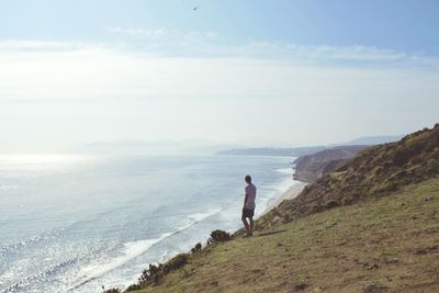 Man looking at sea against sky