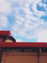 Low angle view of building against cloudy sky