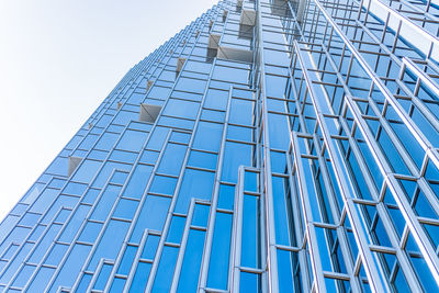 Low angle view of modern building against clear blue sky