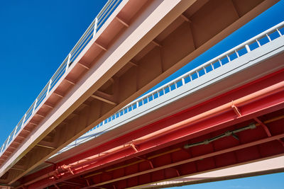 Low angle view of bridge against blue sky