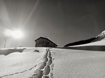 Snow covered land against sky