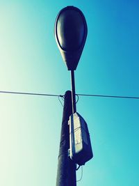 Low angle view of street light against clear blue sky