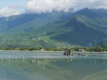 Scenic view of lake and mountains against sky