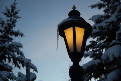 Low angle view of illuminated street light against clear sky