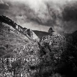 Scenic view of mountains against cloudy sky