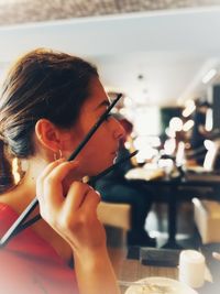 Close-up portrait of a woman sitting on table