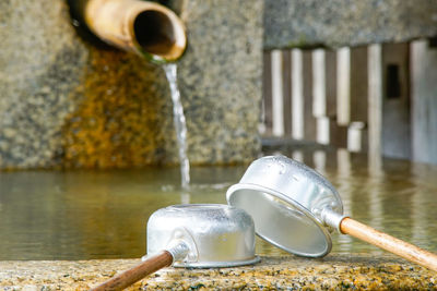 Water pouring from faucet in fountain