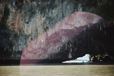 Scenic view of sea by rock formation