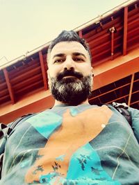 Portrait of young man against built structure