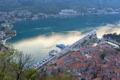 A view from above of the bay with yachts and boats and houses with red tiled roofs. sunset time