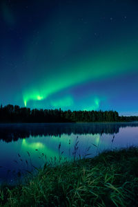 Scenic view of river against sky at night