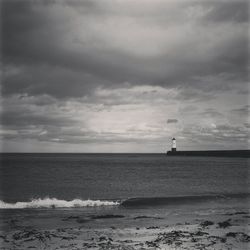 Scenic view of sea against cloudy sky