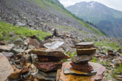 Close-up of stack of stones on field