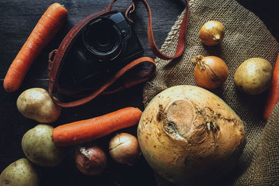 Close-up of vegetables and camera on table