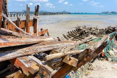 Abandoned boats on beach against sky