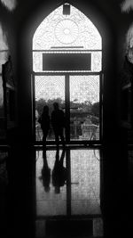 Silhouette people in corridor of building