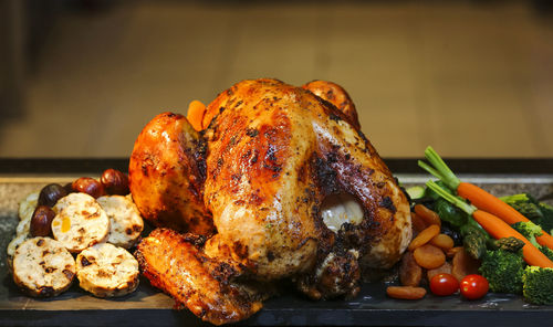 Close-up of roasted chicken on slate