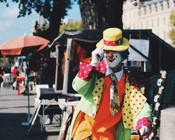 Clown in city on sunny day