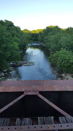 High angle view of river amidst trees in forest against sky