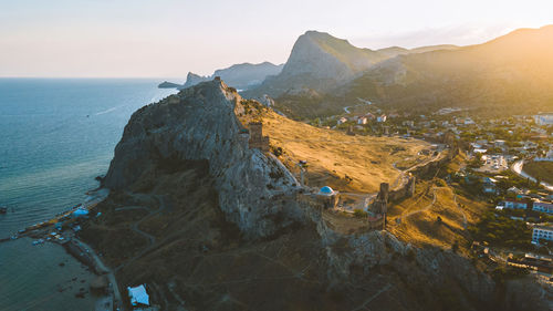 Panoramic view of sea and mountains against sky