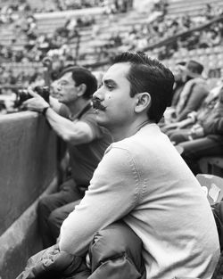 Side view of young man looking away outdoors