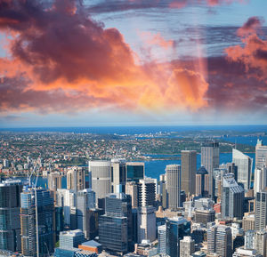 High angle view of buildings against cloudy sky during sunset