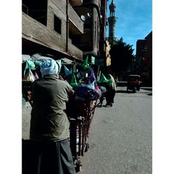 Rear view of woman cycling on street