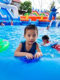 Portrait of cute boy in swimming pool