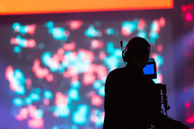 Silhouette man standing at music concert